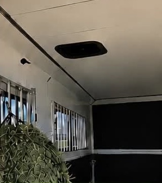Clean interior of the horse trailer with hay net hung and stall dividers